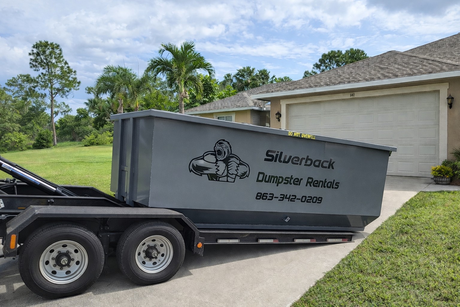 Silverback dumpster rental in a residential driveway